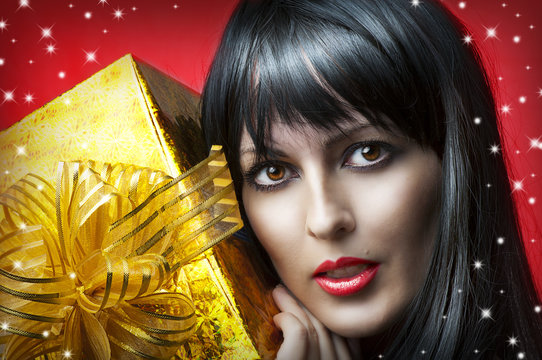 Portrait Of Beauty Woman With Gold Christmas Gift