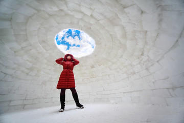 young woman in red jacket standing inside igloo at winter - obrazy, fototapety, plakaty