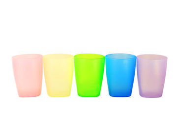 Colorful plastic glasses of various color isolated on white