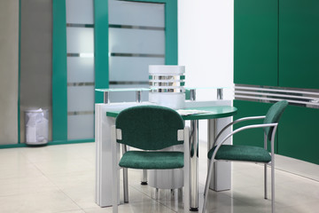 Table and some chairs in clean, simple and empty office