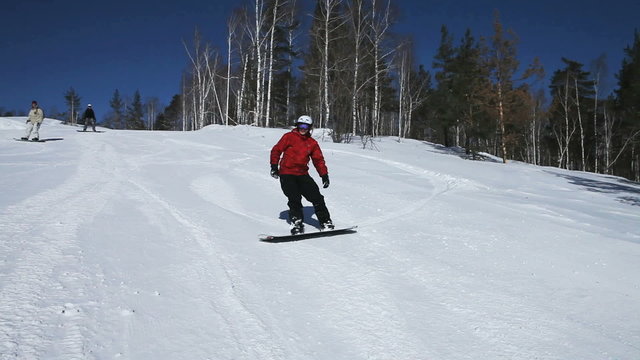 Snowboarder outrunning his friends on a winding ride