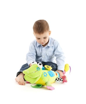 Adorable toddler with cute soft toy