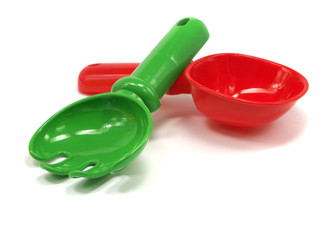 red toy rake and shovel