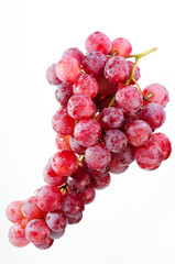 A bunch of red grapes on a white background.