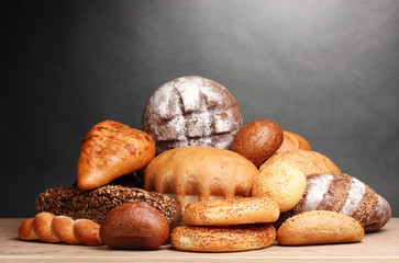 delicious bread on wooden table on gray background