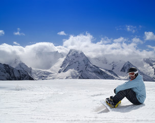 Fototapeta na wymiar Snowboarder resting on the ski slope