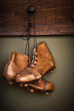 Vintage football boots hanging on a locker room