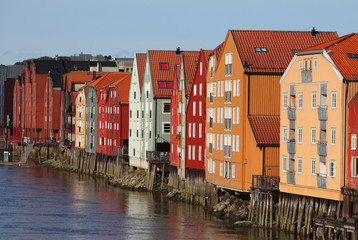 Fototapeta na wymiar Row of colorful wooden houses beside the river in Trondheim