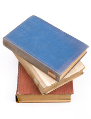 Old books piled together over white background