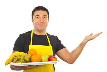 Smiling greengrocer making presentation