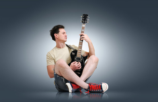 Young man plays the electric guitar, sound concept