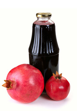 Bottle of juice and ripe pomegranate