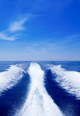 Boat wake prop wash on blue ocean sea