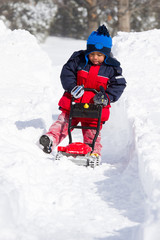 Child Cleaning Snow with Toy Outdoor