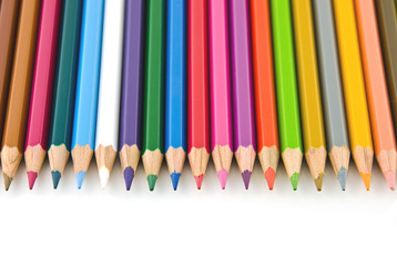 Set of colorful color pencil lined in row on white background.