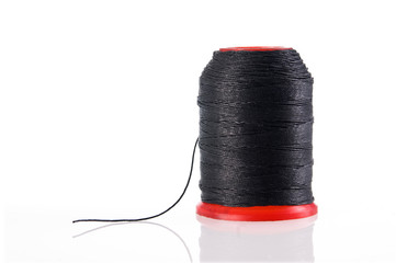 Spool of black thread  isolated with clipping path