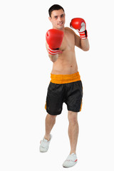Young male boxer performing uppercut