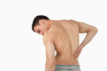 Back view of man suffering from back pain