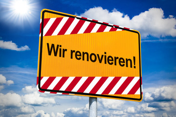 Ortseingangsschild mit Wir renovieren