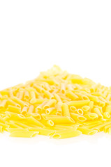 Penne pasta pilled up on a white background