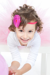 Little girl with pink balloon in studio