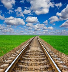 railway leaving far among a green fields