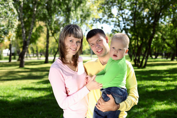 Young family with a child in summer park
