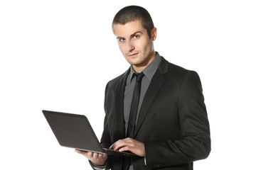 Young businessman working on laptop over white background