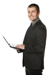 Young businessman working on laptop over white