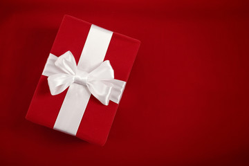 Gift box on red velvet background