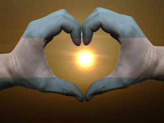 Heart and love gesture by hands colored in argentina flag during