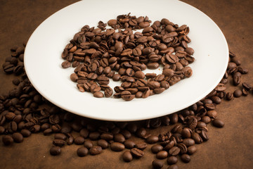 Coffee beans on a white plate