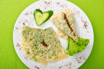 Pancake with herbs in the plate