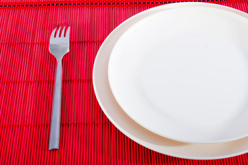 Empty plate with utensils