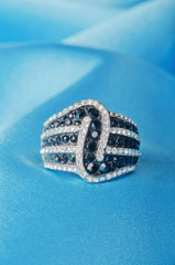 Jewellery ring on the satin background