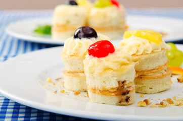 Plate full of tasty mini cakes