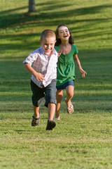 Obraz premium Two Young Children Running and Playing