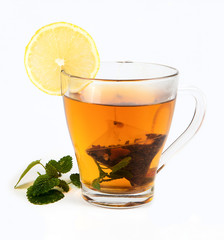 tea in cup with leaf mint and lemon isolated on white background