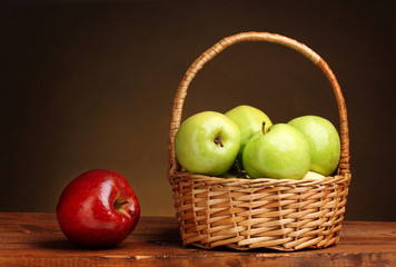 juicy green apples in basket and red apple