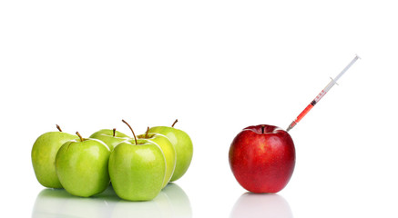 red and green apples and syringe isolated on white