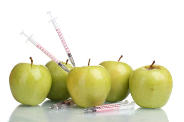 green apples and syringes isolated on white