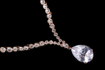 Fototapeta na wymiar beautiful gold necklace with jewels stones on black background