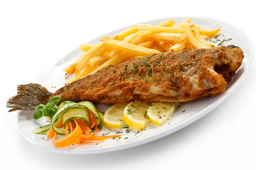 Fish dish - fried fish, French fries and vegetables