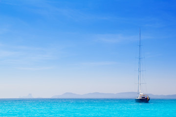 Ibiza mountains with sailboat from Formentera