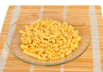 Macaroni in a transparent plate on straw mat