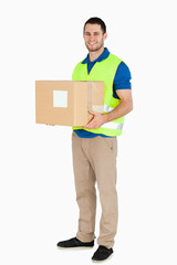 Smiling young delivery man holding a parcel