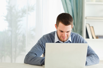 Man working concentrated on his notebook in his homeoffice