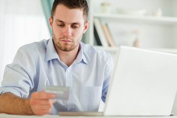 Businessman with credit card and laptop