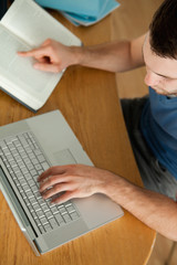 Student using notebook for his homework