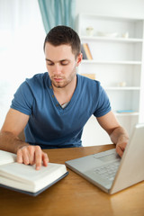 Student researching with his laptop